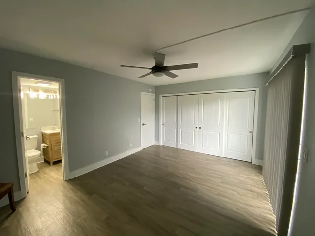 a view of an empty room and a bathroom