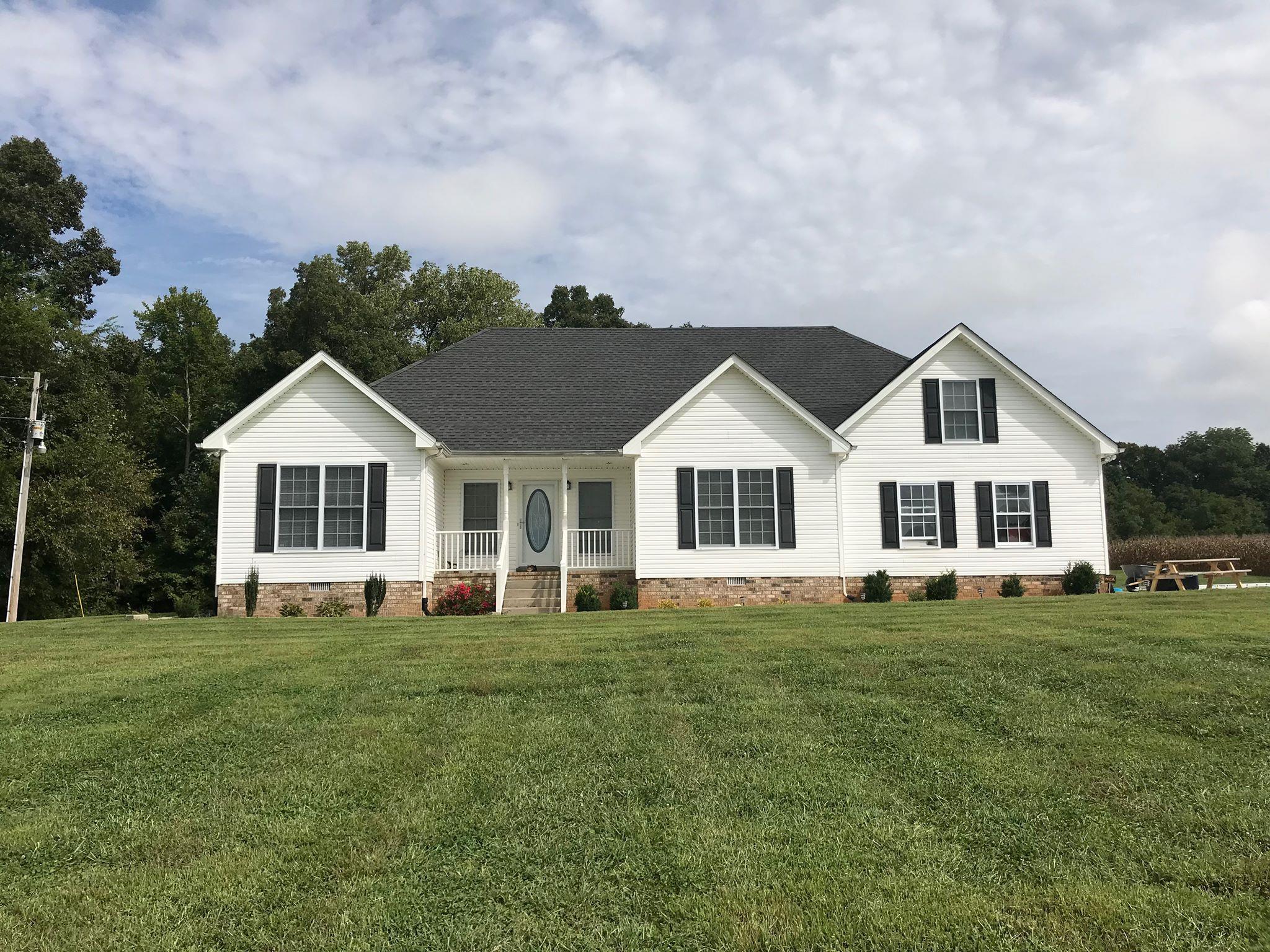 2220 Kinneys Road Cedar Hill, TN 37032 - Photo 2 of 23 a front view of a house with a yard and trees