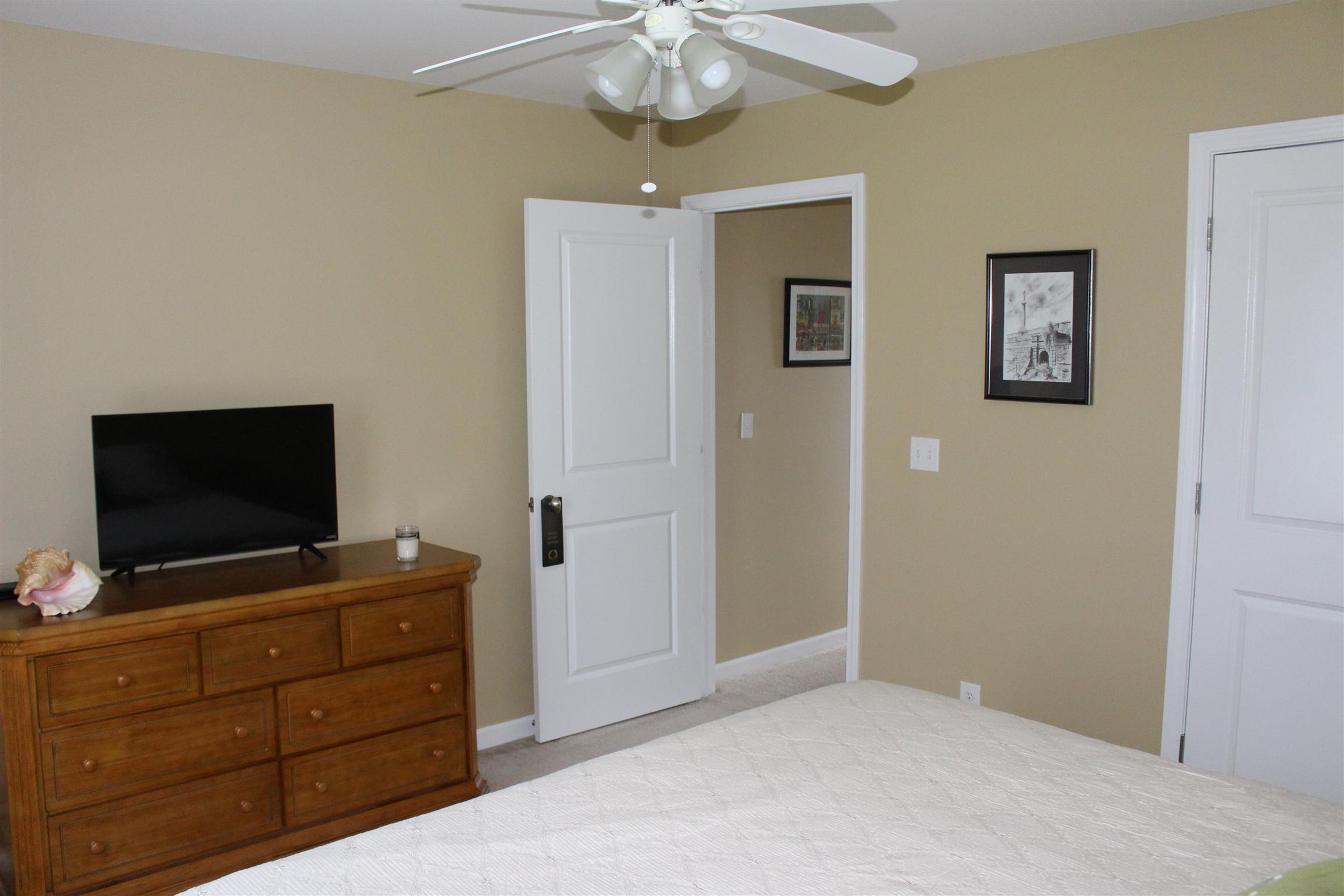 2220 Kinneys Road Cedar Hill, TN 37032 - Photo 21 of 23 a bedroom with a bed and flat screen tv