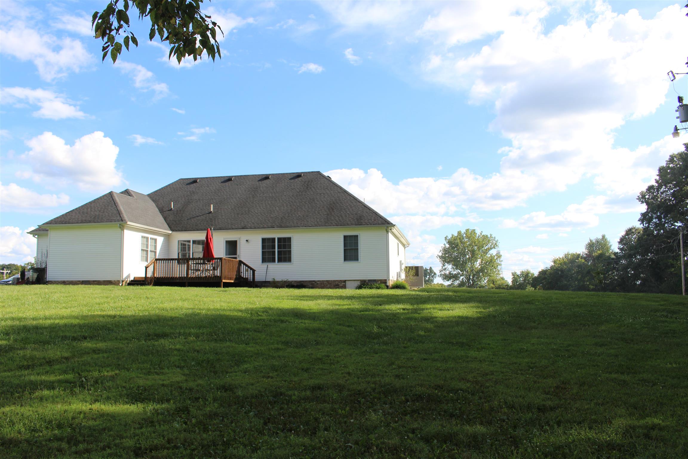 2220 Kinneys Road Cedar Hill, TN 37032 - Photo 22 of 23 a backyard of a house with table and chairs