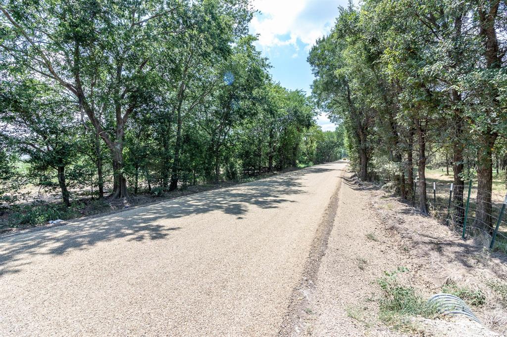 0 Cr-4076 Scurry, TX 75158 - Photo 12 of 12 a view of a dirt road with trees in the background