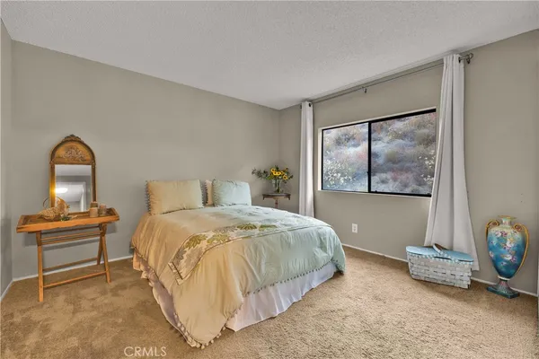 a bedroom with a bed and window