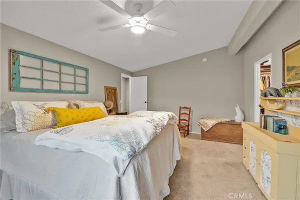 a bedroom with bed and a chandelier