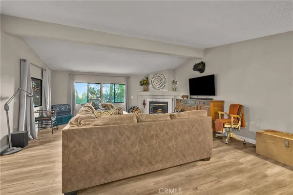 a living room with furniture flat screen tv and a fireplace