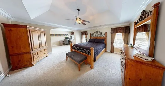 a living room with furniture a flat screen tv and a refrigerator