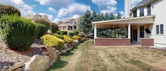 a view of a house with a yard and garden