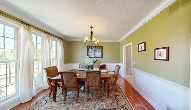 a view of a dining room with furniture window and wooden floor