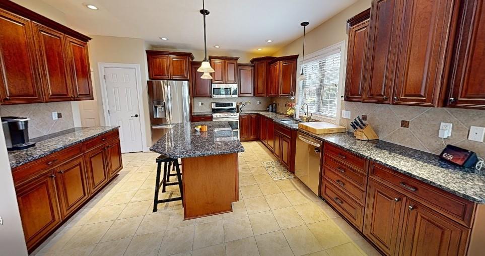 150 Eric Drive Beaver, PA 15009 - Photo 9 of 35 a kitchen with stainless steel appliances granite countertop wooden cabinets a sink dishwasher a stove and a refrigerator