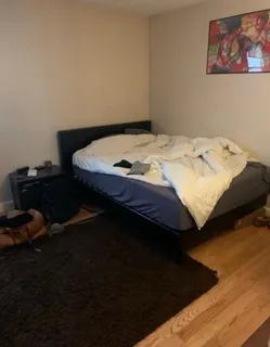 a bedroom with bed and window