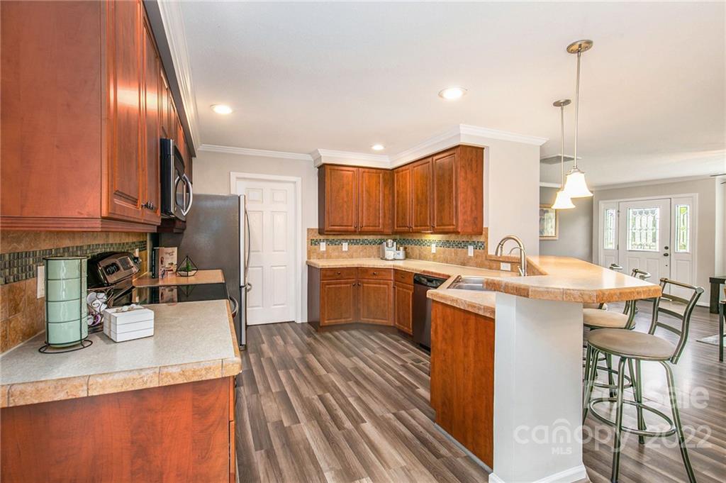 6130 Long Ferry Road Salisbury, NC 28146 - Photo 16 of 32 a kitchen with a sink a counter top space stainless steel appliances and cabinets