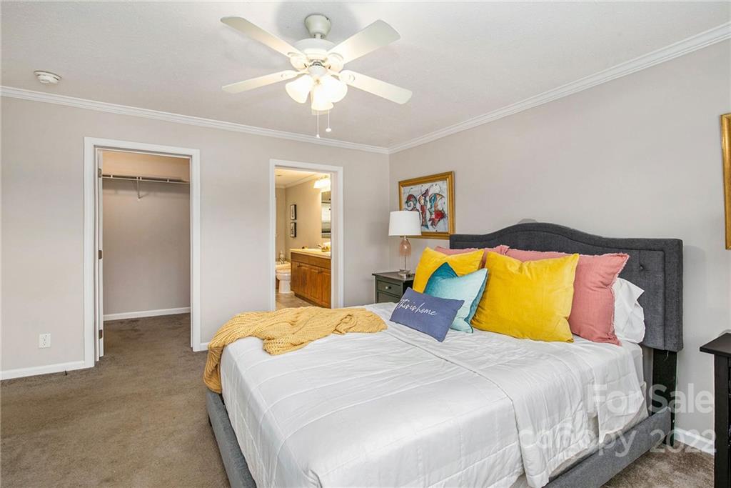 6130 Long Ferry Road Salisbury, NC 28146 - Photo 19 of 32 a bedroom with a bed and a chandelier