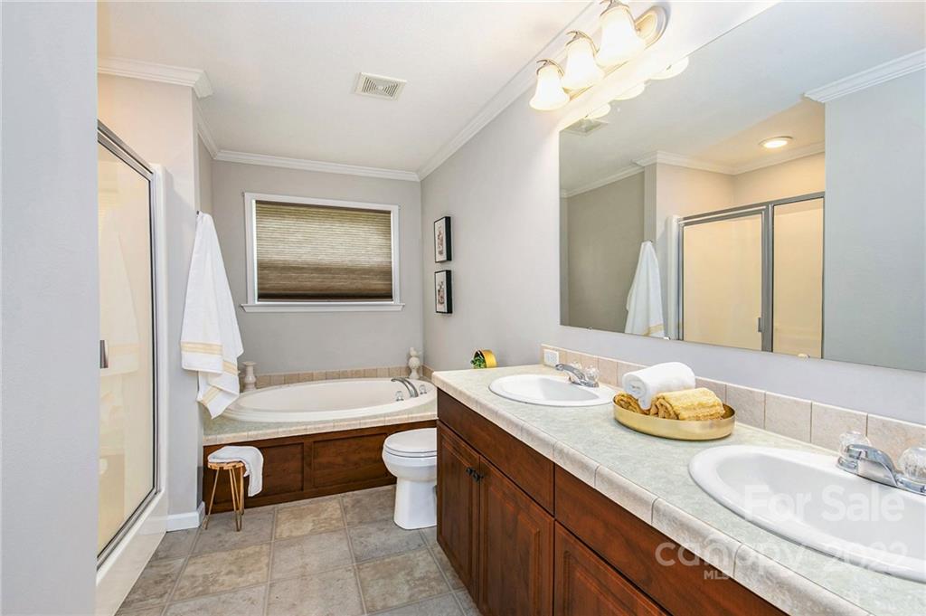 6130 Long Ferry Road Salisbury, NC 28146 - Photo 21 of 32 a bathroom with a granite countertop sink and a mirror