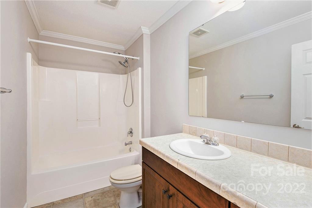 6130 Long Ferry Road Salisbury, NC 28146 - Photo 25 of 32 a bathroom with a granite countertop sink toilet and shower