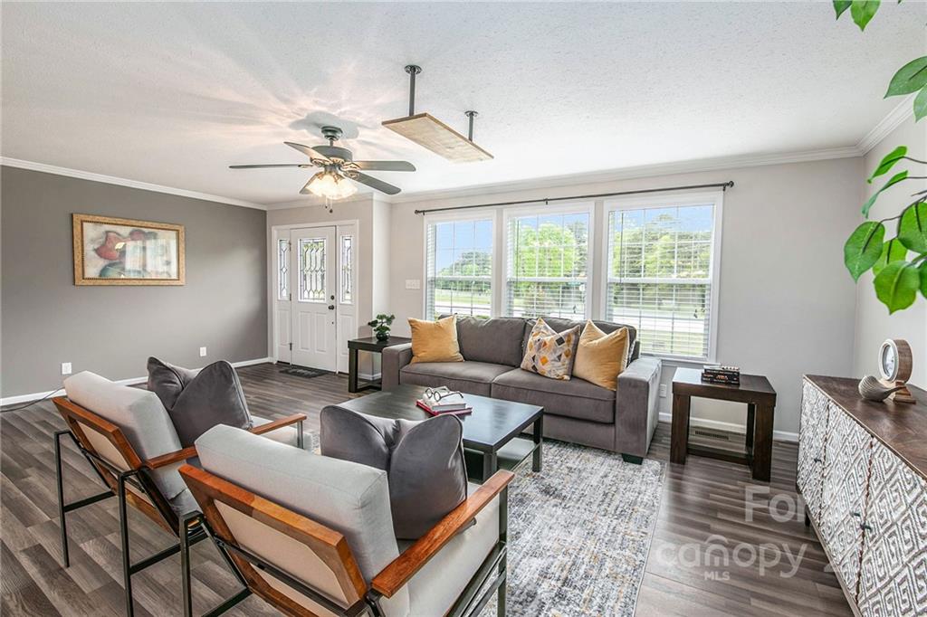 6130 Long Ferry Road Salisbury, NC 28146 - Photo 7 of 32 a living room with furniture a chandelier and a window