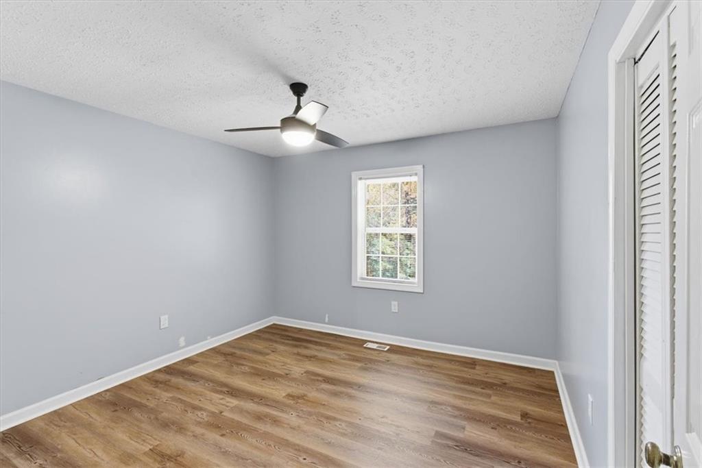 1500 Moores Ferry Road Southwest Plainville, GA 30733 - Photo 30 of 33 an empty room with wooden floor and windows