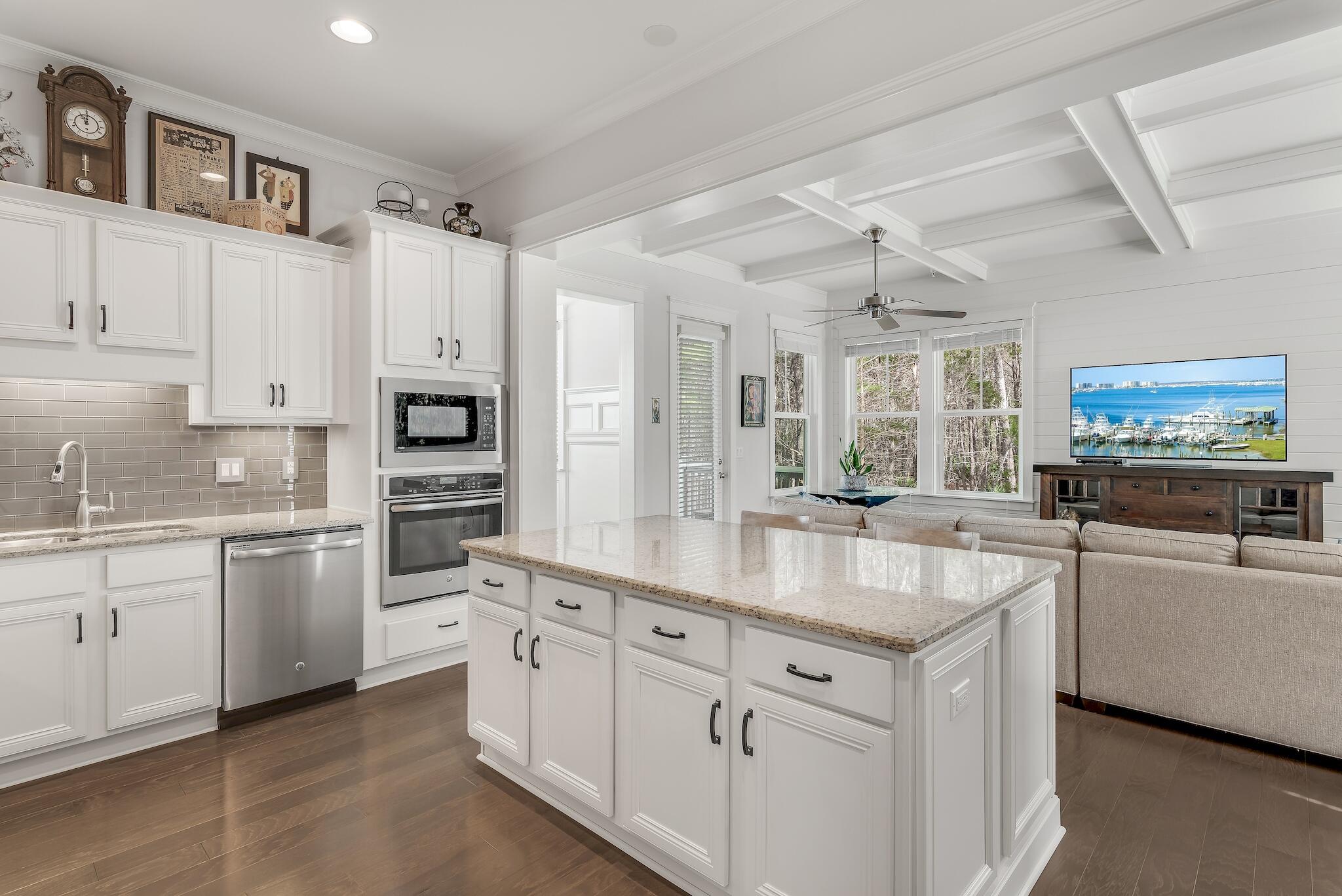 128 Emerald Beach Circle Santa Rosa Beach, FL 32459 - Photo 17 of 48 a kitchen with white cabinets and white appliances