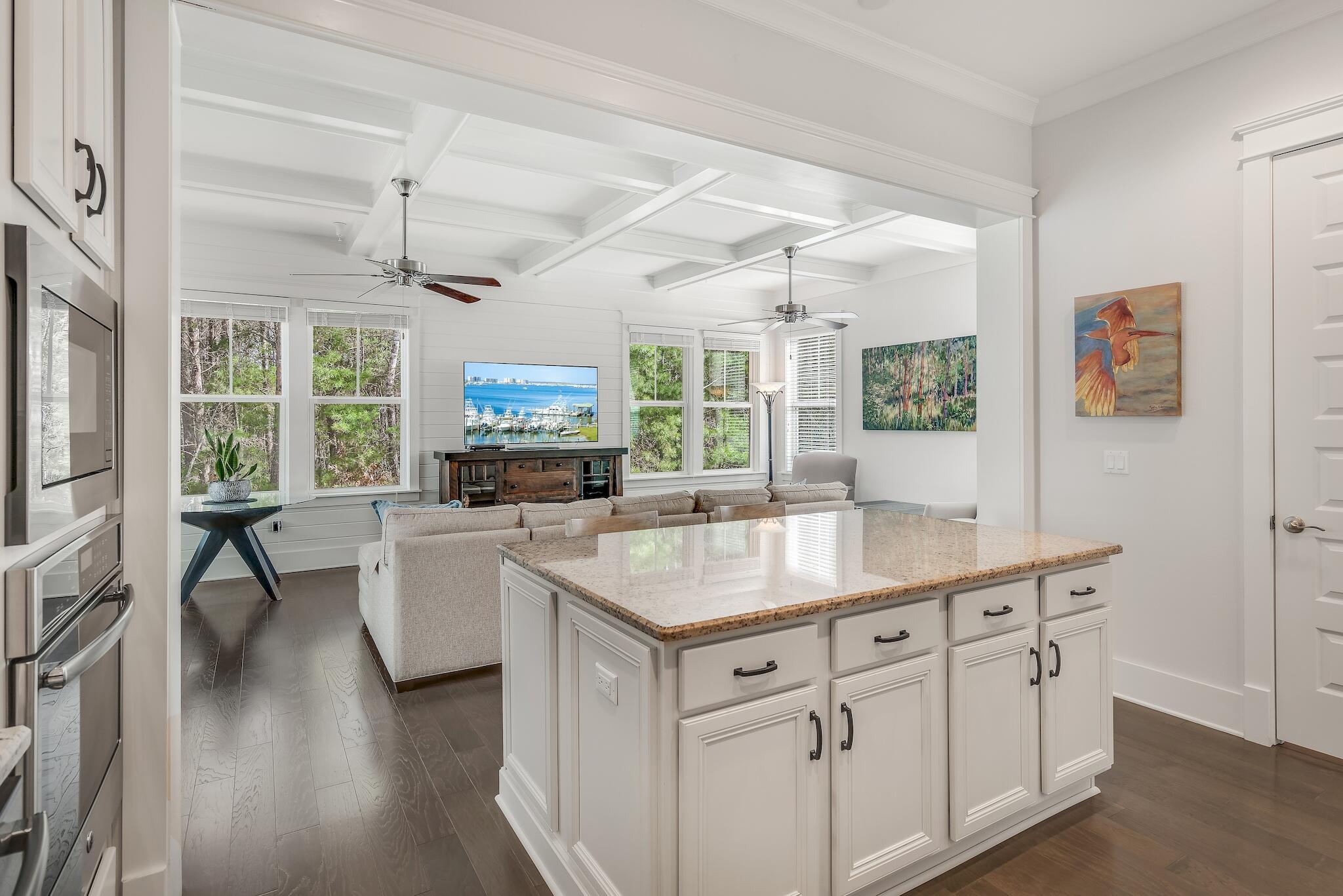 128 Emerald Beach Circle Santa Rosa Beach, FL 32459 - Photo 18 of 48 a kitchen with stainless steel appliances granite countertop a lot of counter space and a wooden floors