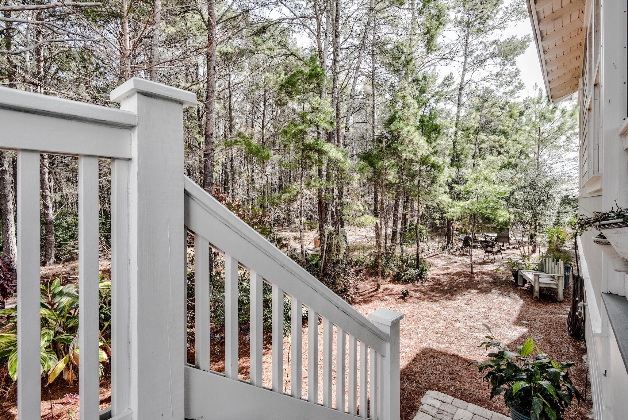 128 Emerald Beach Circle Santa Rosa Beach, FL 32459 - Photo 23 of 48 a view of balcony with furniture and trees