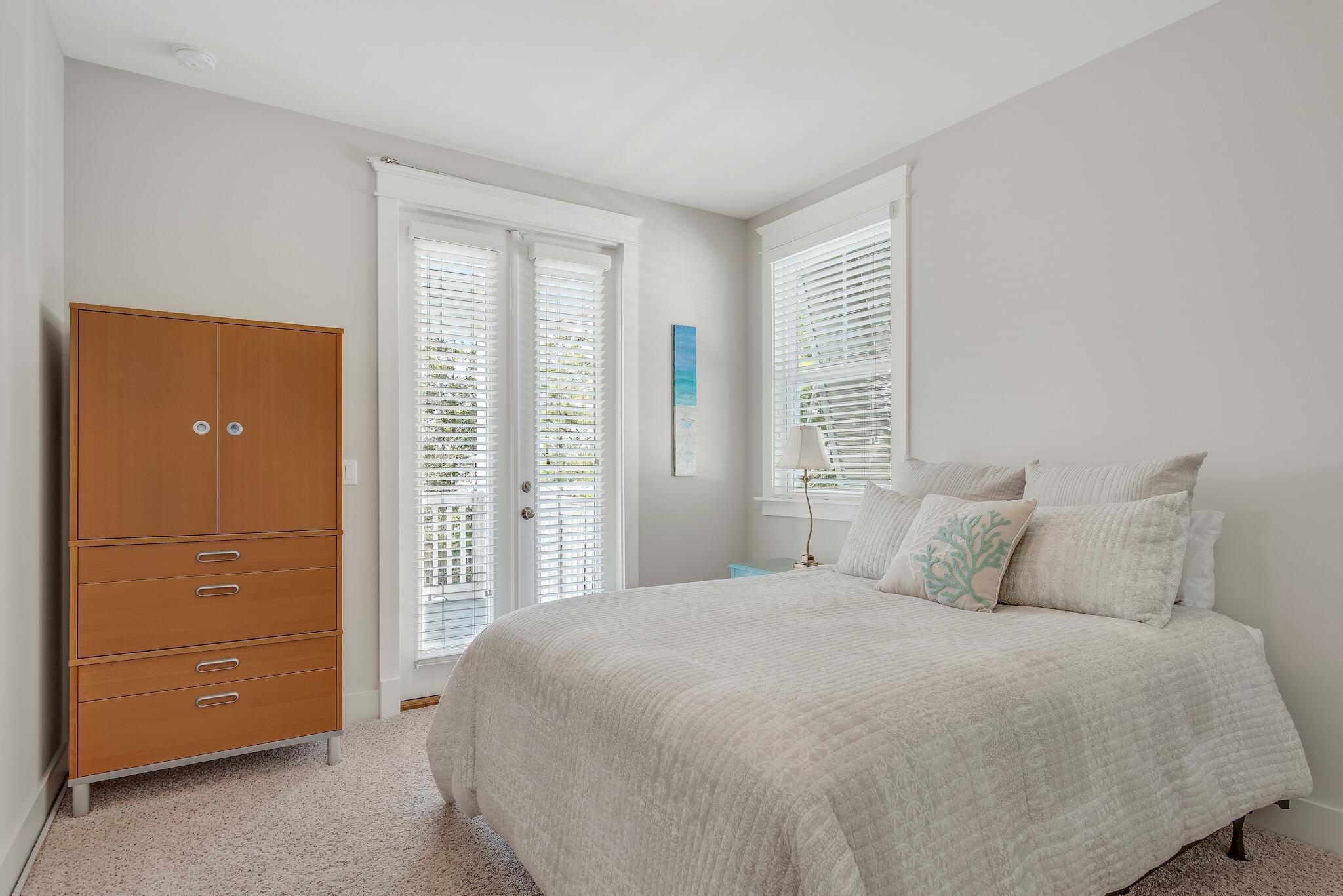 128 Emerald Beach Circle Santa Rosa Beach, FL 32459 - Photo 27 of 48 a bedroom with a bed and a dresser