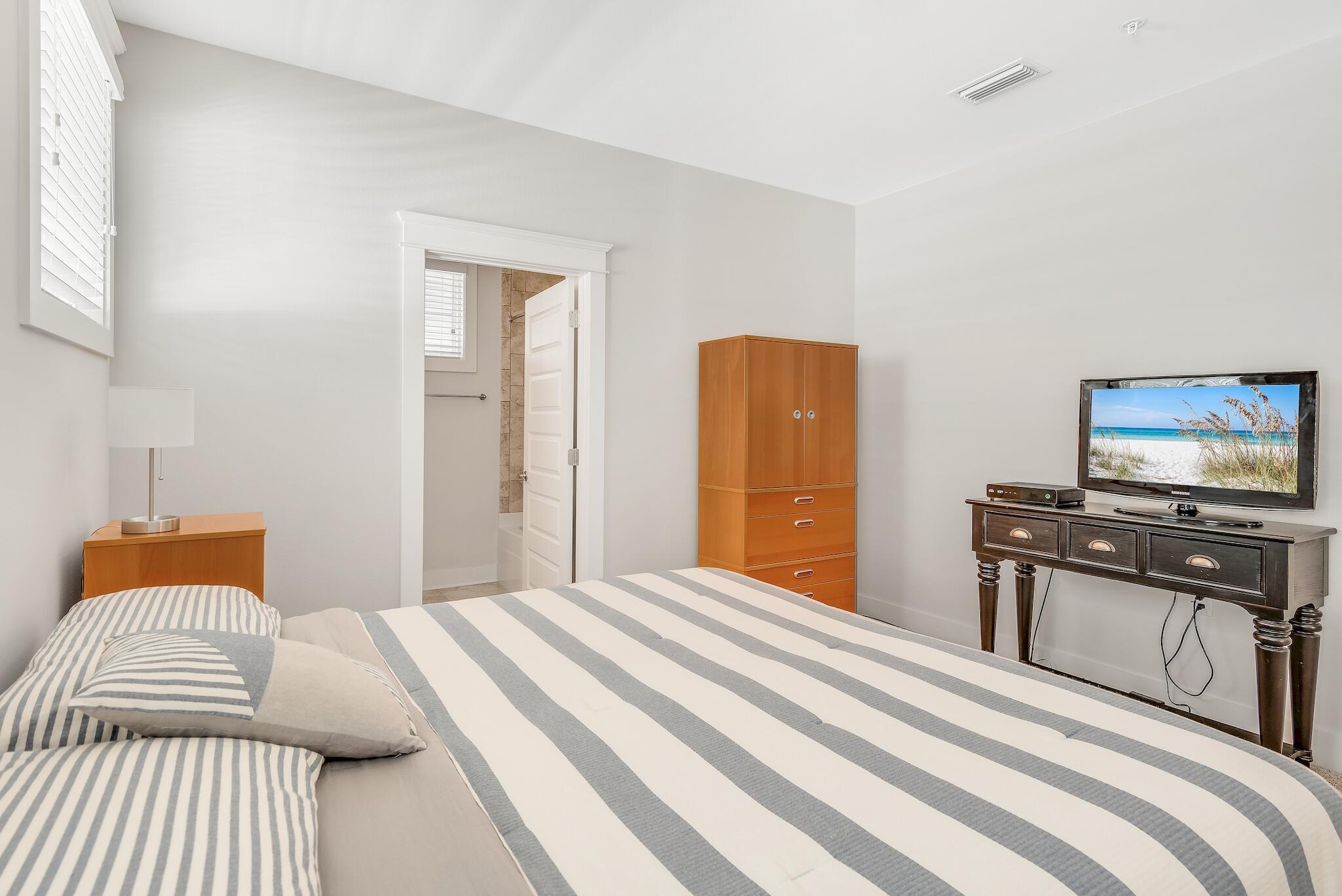 128 Emerald Beach Circle Santa Rosa Beach, FL 32459 - Photo 28 of 48 a bedroom with a bed and a flat screen tv