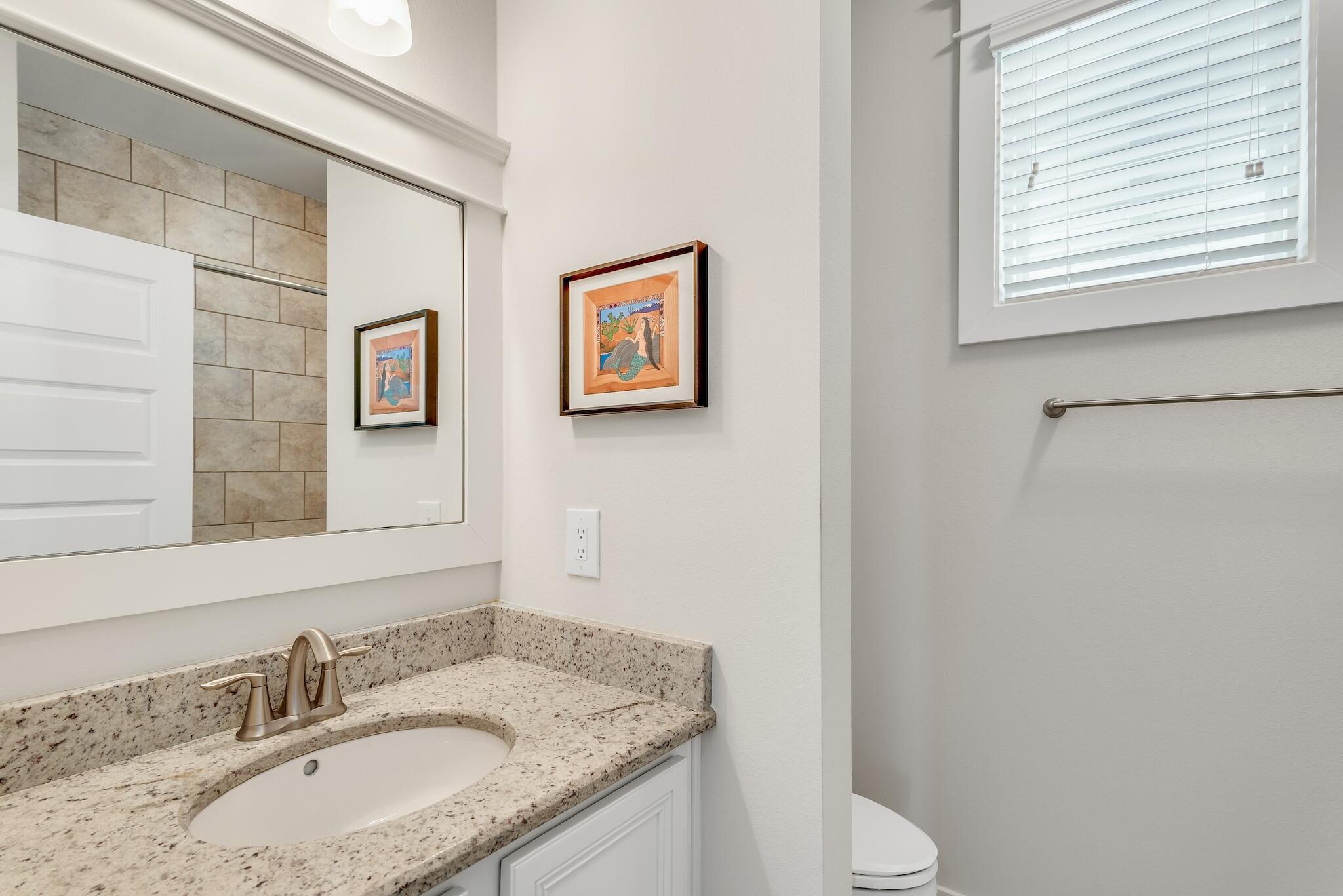 128 Emerald Beach Circle Santa Rosa Beach, FL 32459 - Photo 29 of 48 a bathroom with a granite countertop sink toilet and a mirror