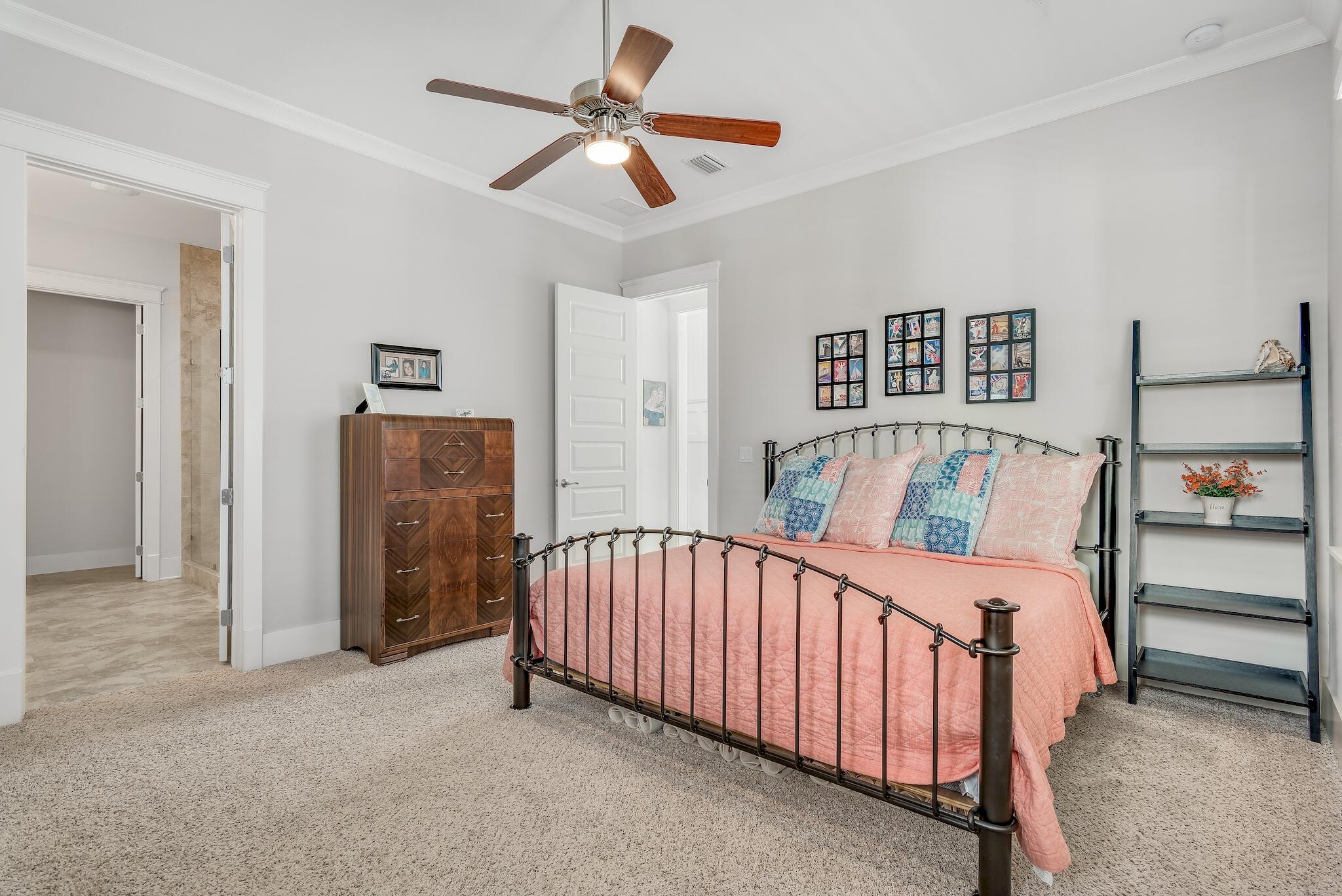 128 Emerald Beach Circle Santa Rosa Beach, FL 32459 - Photo 36 of 48 a bedroom with furniture and a chandelier fan