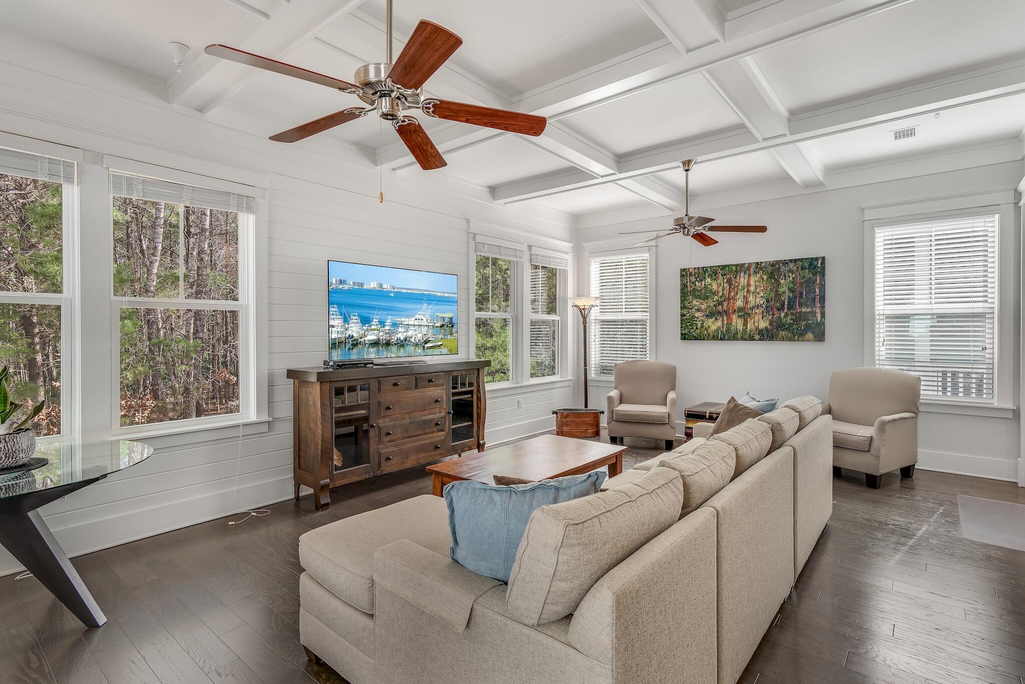 128 Emerald Beach Circle Santa Rosa Beach, FL 32459 - Photo 10 of 48 a living room with furniture a fireplace and a flat screen tv