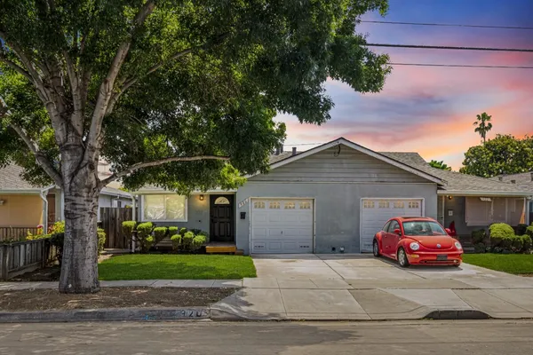 a view of a house with a yard and garage