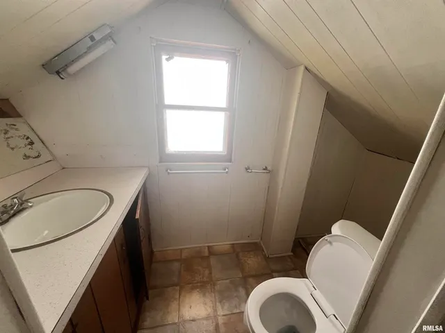 a bathroom with a sink toilet and mirror
