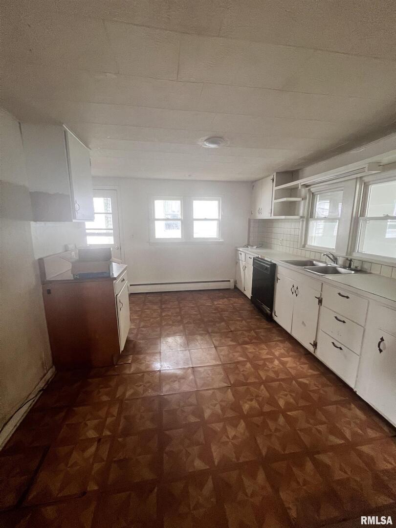 307 Morgan Street Anna, IL 62906 - Photo 5 of 15 a large white kitchen with cabinets and a window