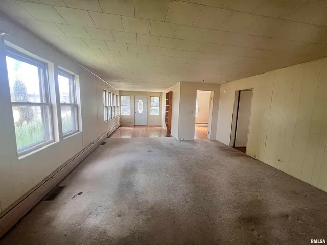 a view of an empty room with windows