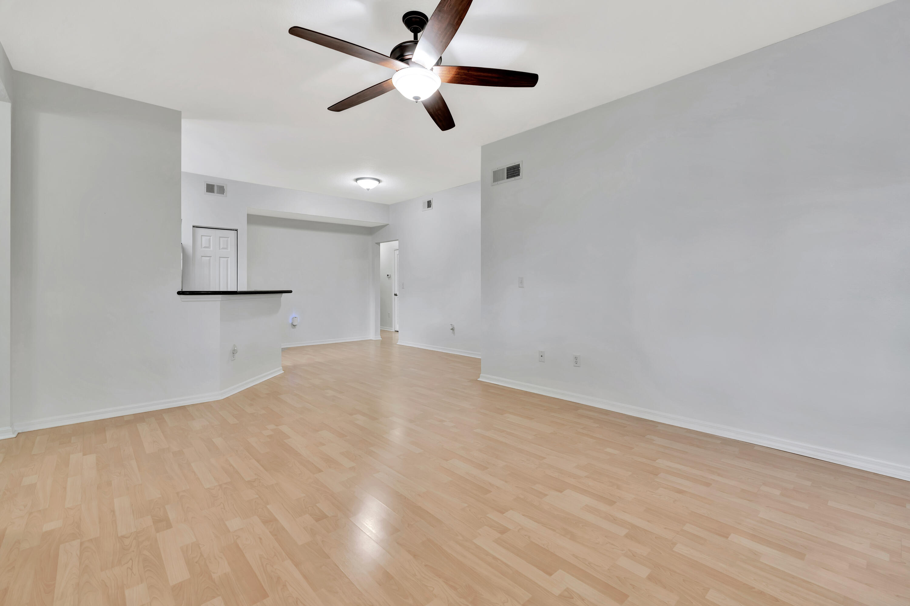 1561 Southeast Pomeroy Street Stuart, FL 34997 - Photo 11 of 25 an empty room with a ceiling fan and a ceiling fan