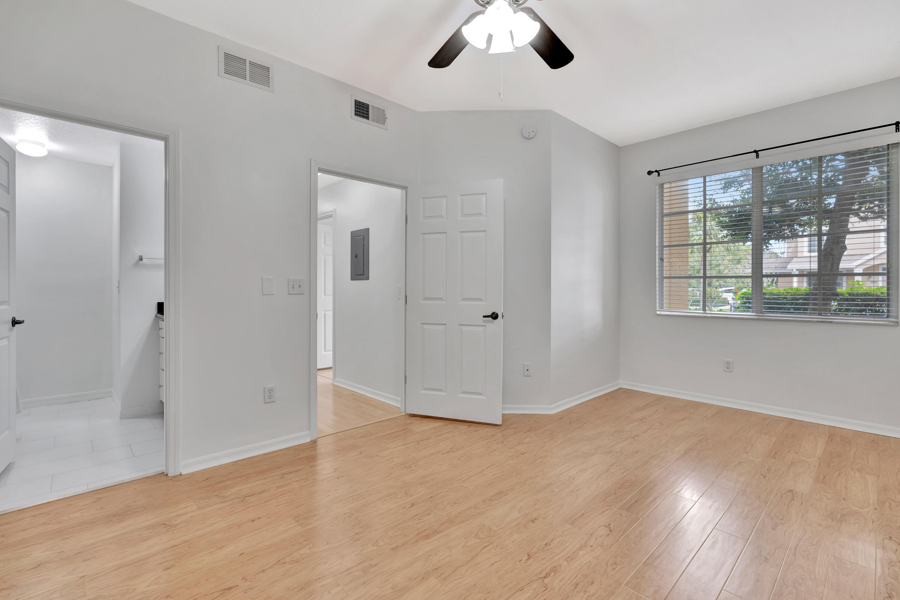 1561 Southeast Pomeroy Street Stuart, FL 34997 - Photo 14 of 25 wooden floor in an empty room with a window