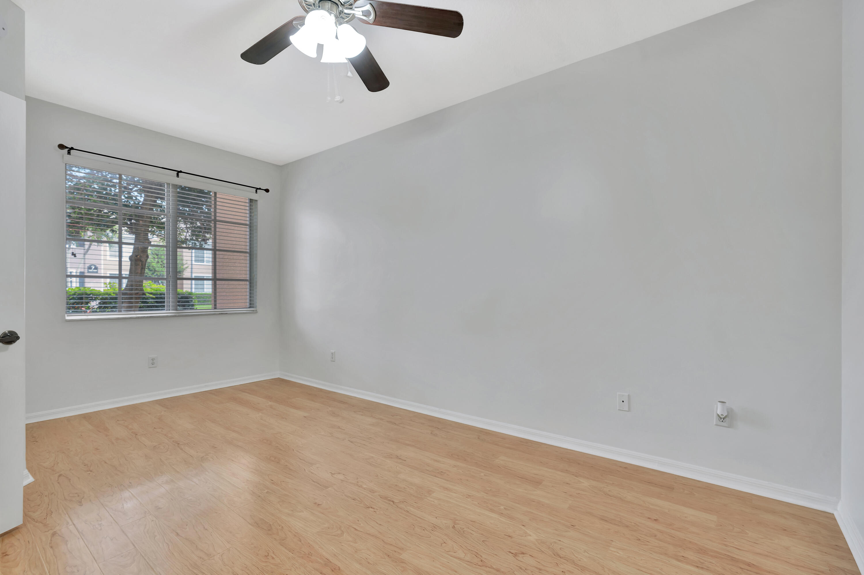 1561 Southeast Pomeroy Street Stuart, FL 34997 - Photo 17 of 25 an empty room with a window and a ceiling fan