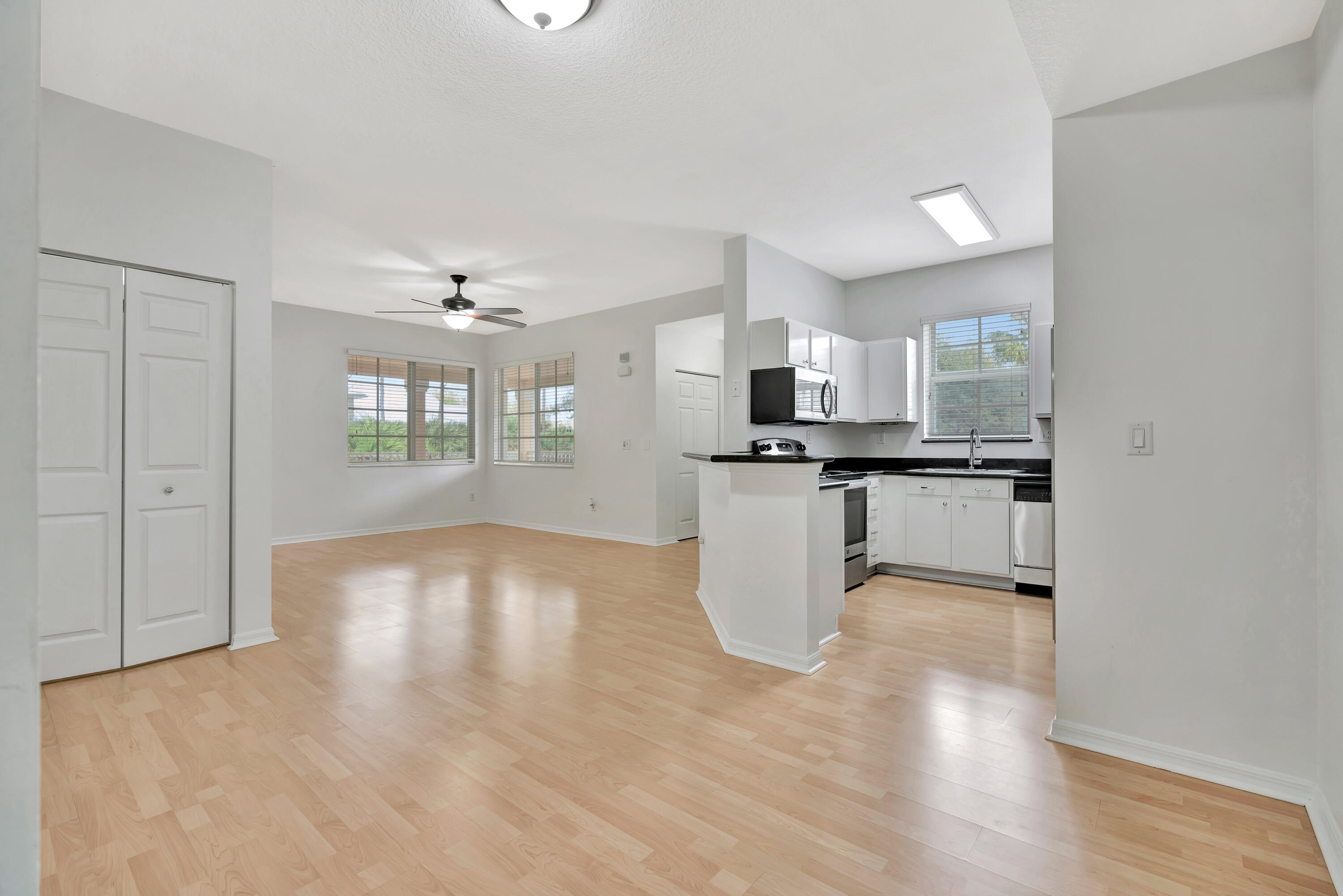 1561 Southeast Pomeroy Street Stuart, FL 34997 - Photo 5 of 25 a view of a kitchen with kitchen island and stainless steel appliances