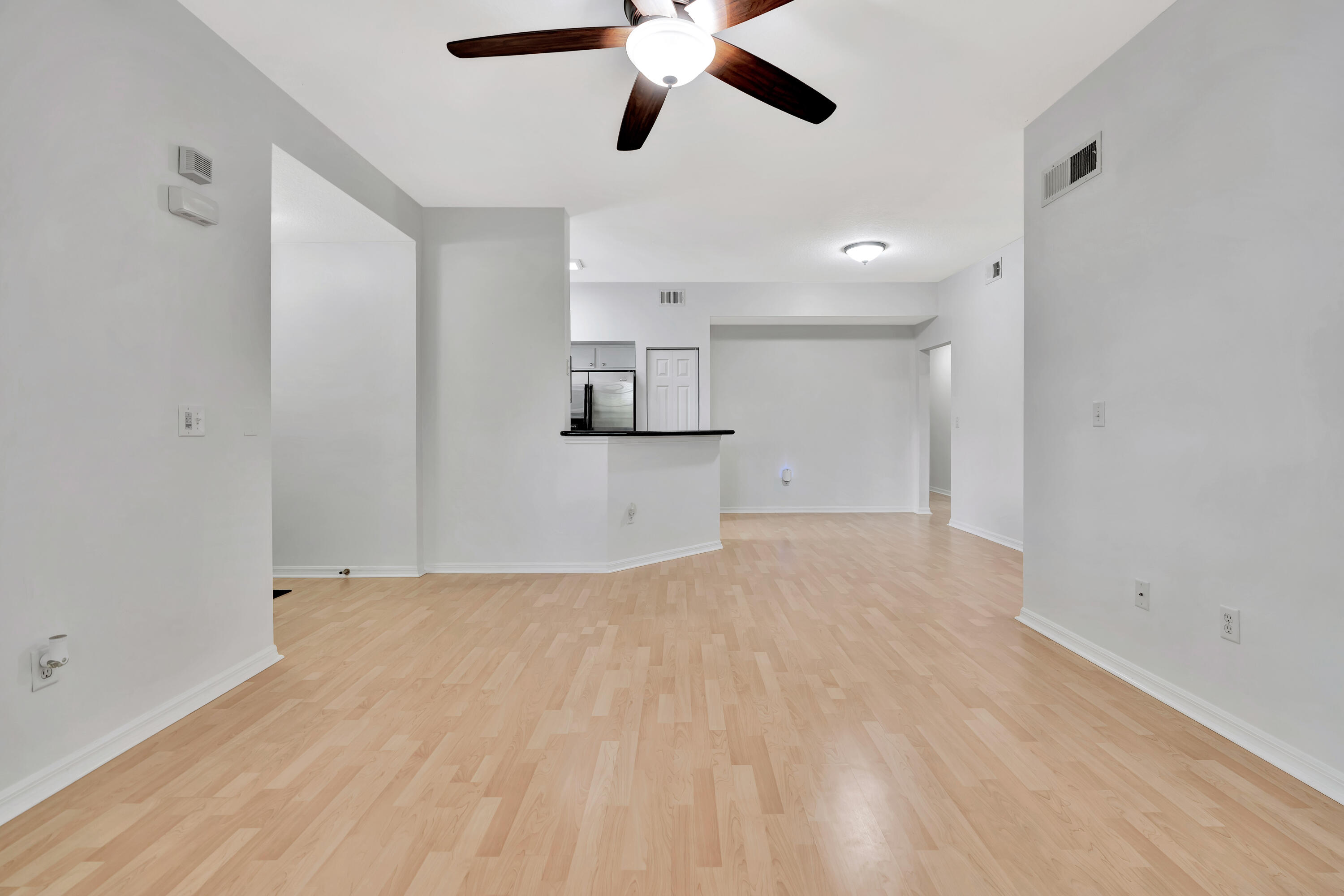 1561 Southeast Pomeroy Street Stuart, FL 34997 - Photo 10 of 25 a view of empty room with wooden floor and ceiling fan