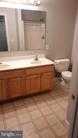 a bathroom with a sink a toilet and mirror