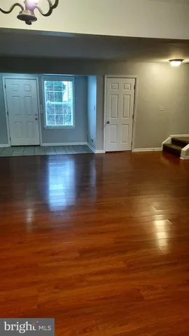 a view of room with window and wooden floor