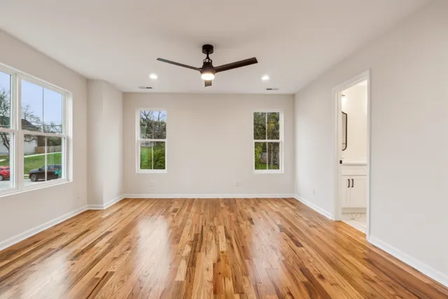 wooden floor in an empty room with a window