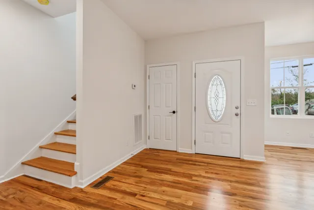 a view of a room with wooden floor and white walls