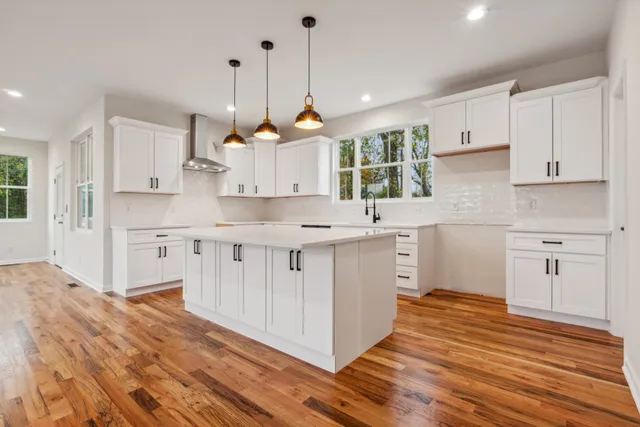 a kitchen with kitchen island white cabinets and white appliances