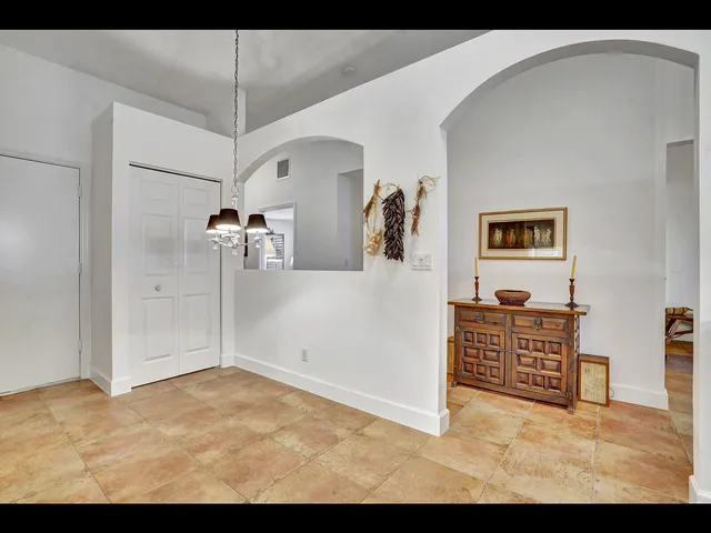 a bedroom with a bed potted plant and a window