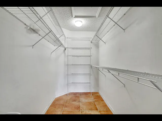 a work room with furniture and a flat screen tv