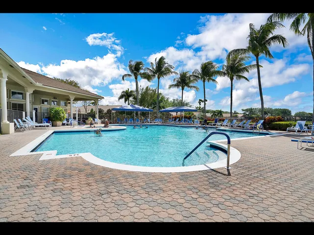 a living room with patio furniture and a large window
