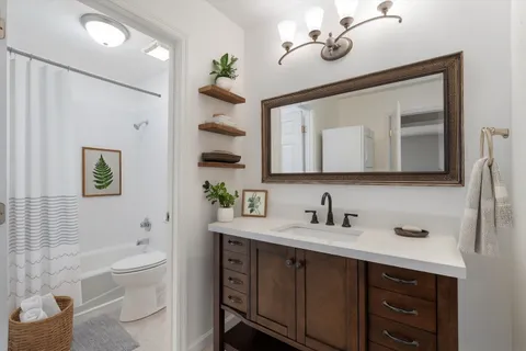 a bathroom with a sink a toilet and bathtub