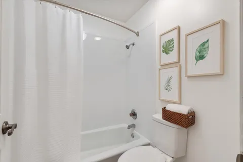 a bathroom with a toilet and a bathtub