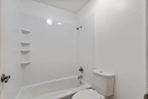 a bedroom with bed and cabinet