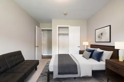 a living room with a couch and a dresser