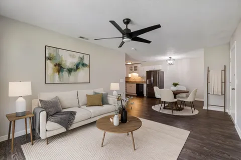 a view of empty room with wooden floor and ceiling fan