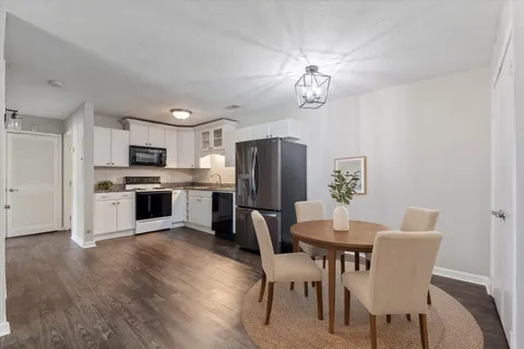 a kitchen with stainless steel appliances granite countertop a refrigerator and a stove top oven